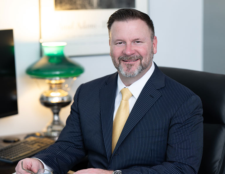 Attorney Ryan Couzens sitting in office chair