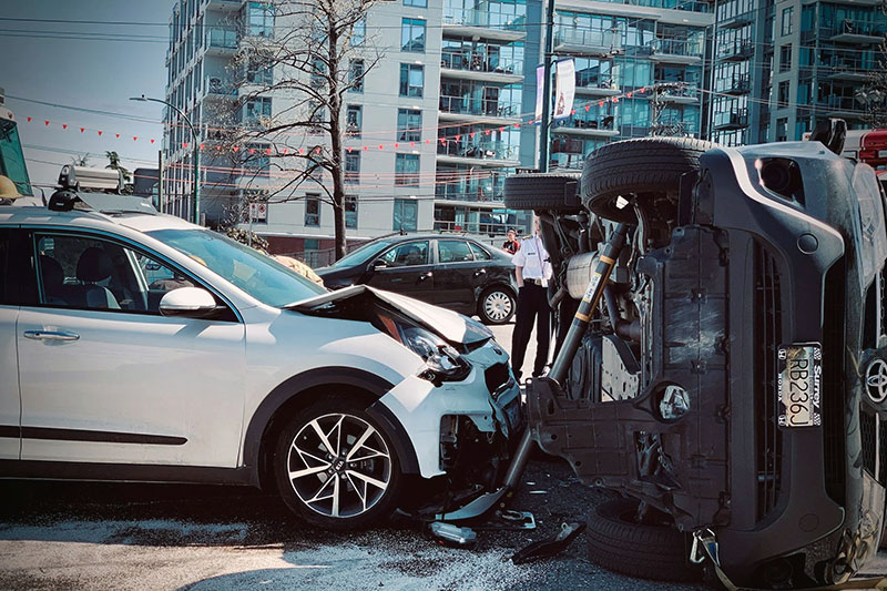 Two cars in collision, one on its side