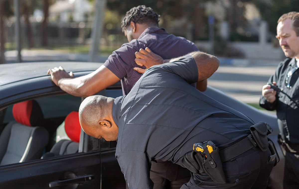 Man being arrested by two police officers.